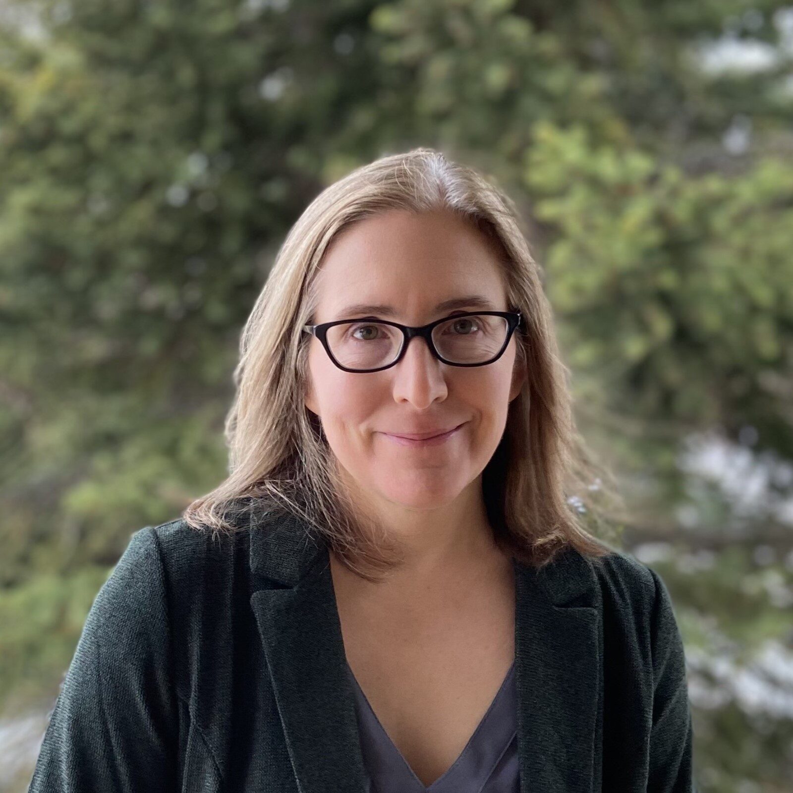 A headshot of a woman looking at the camera