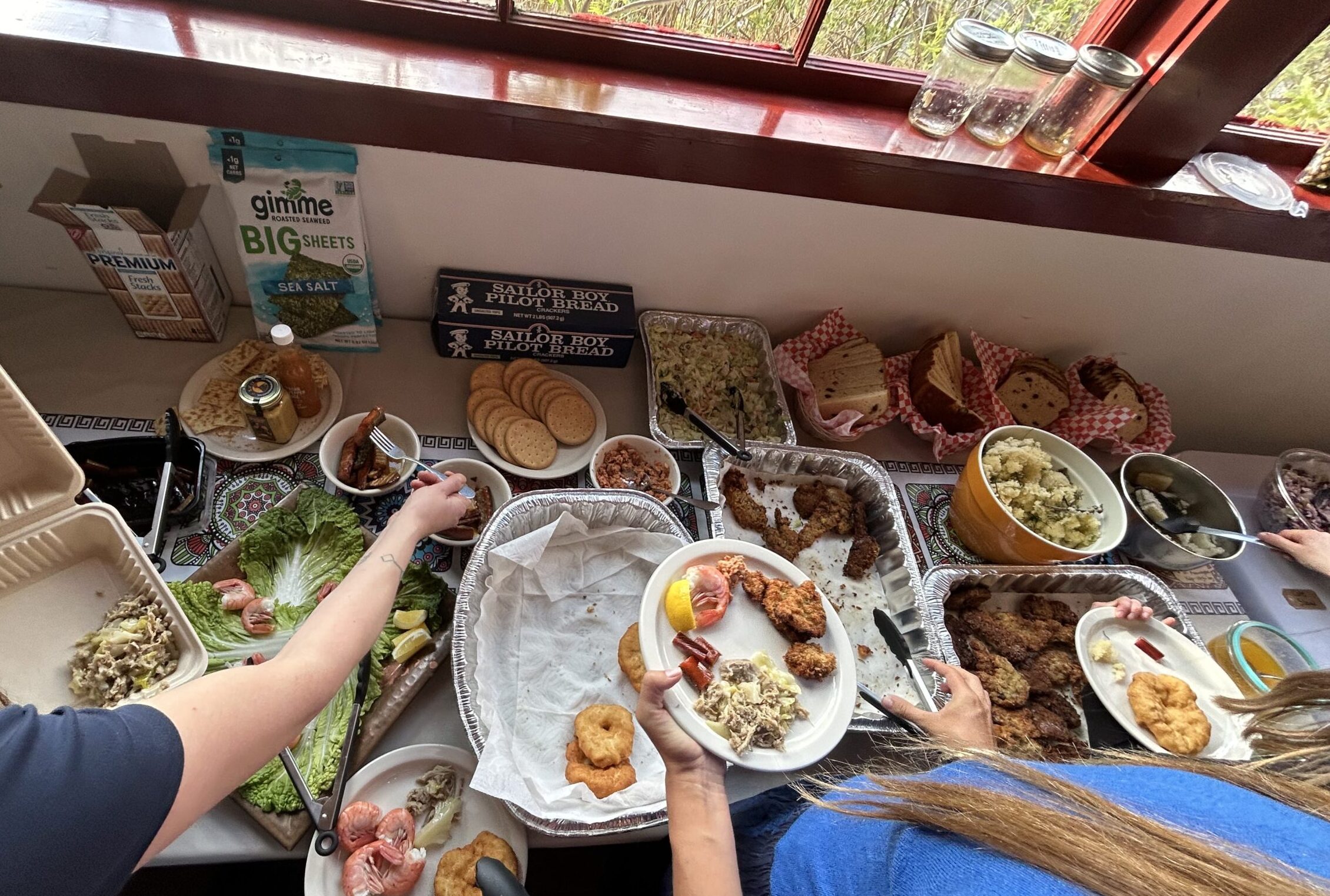 People enjoying a diverse buffet with fried chicken and sides