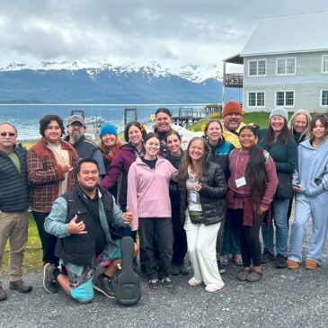 Group enjoying scenic view near a lake and mountains